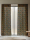 A sheer curtain panel featuring a repeating pattern of amber and forest green peacocks with botanical fan motifs on a dark background, creating a sophisticated Victorian gothic design.